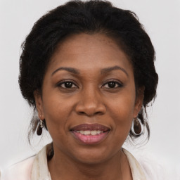 Joyful black adult female with medium  brown hair and brown eyes