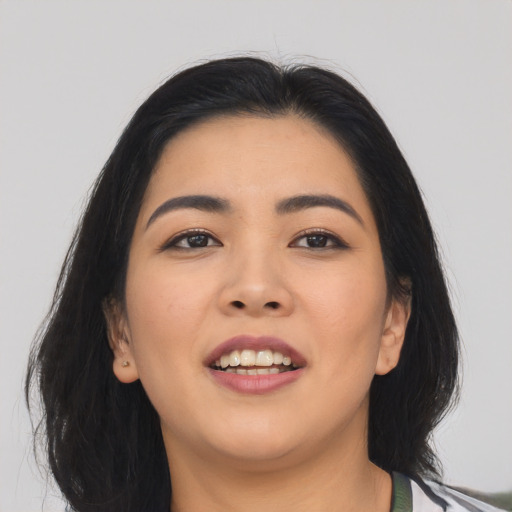 Joyful asian young-adult female with long  brown hair and brown eyes