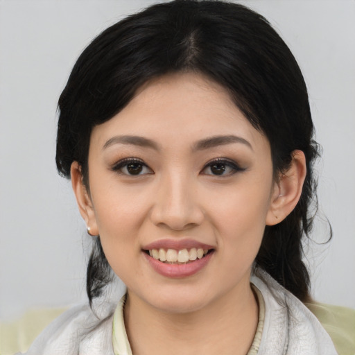 Joyful asian young-adult female with medium  black hair and brown eyes
