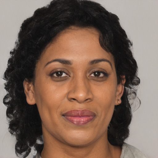Joyful black adult female with medium  black hair and brown eyes