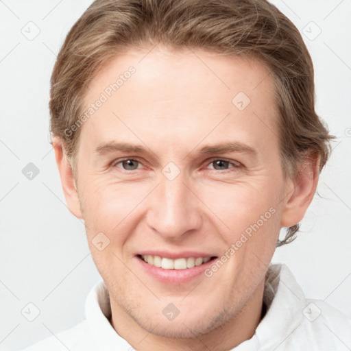 Joyful white adult male with short  brown hair and grey eyes