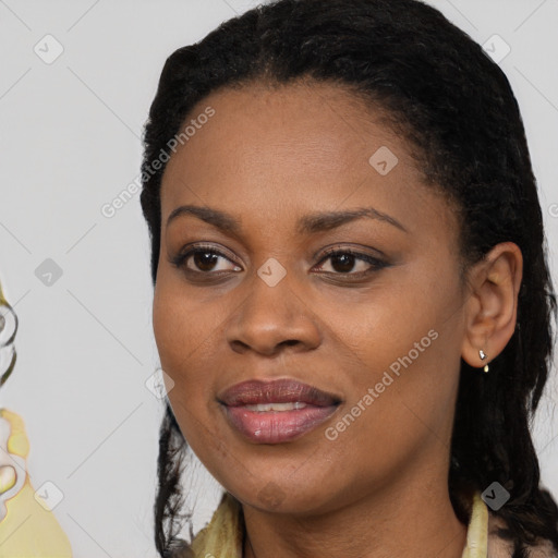 Joyful black young-adult female with long  black hair and brown eyes