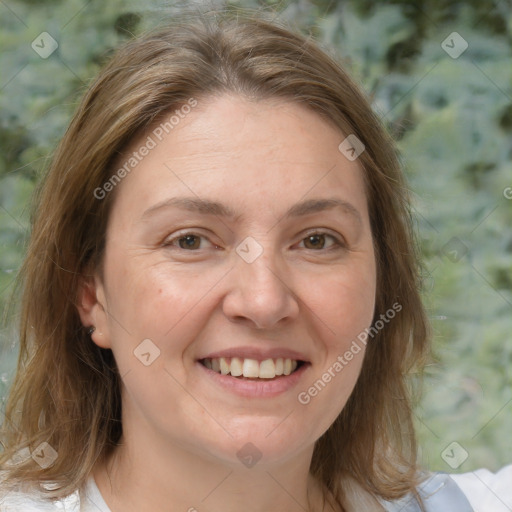 Joyful white adult female with medium  brown hair and brown eyes