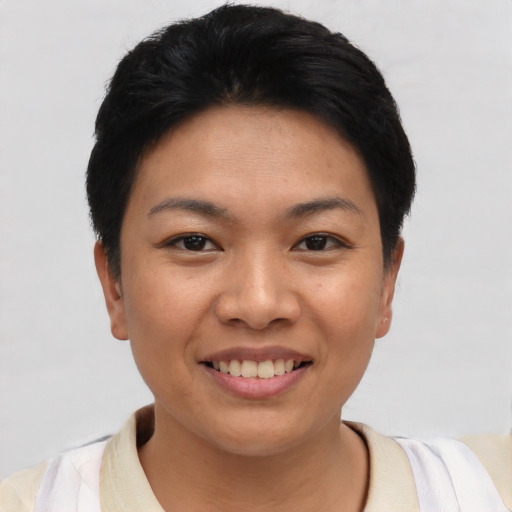 Joyful asian young-adult female with short  black hair and brown eyes