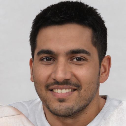 Joyful latino young-adult male with short  black hair and brown eyes