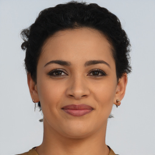 Joyful latino young-adult female with short  brown hair and brown eyes
