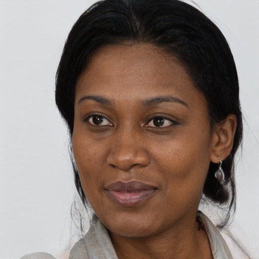 Joyful black adult female with medium  black hair and brown eyes