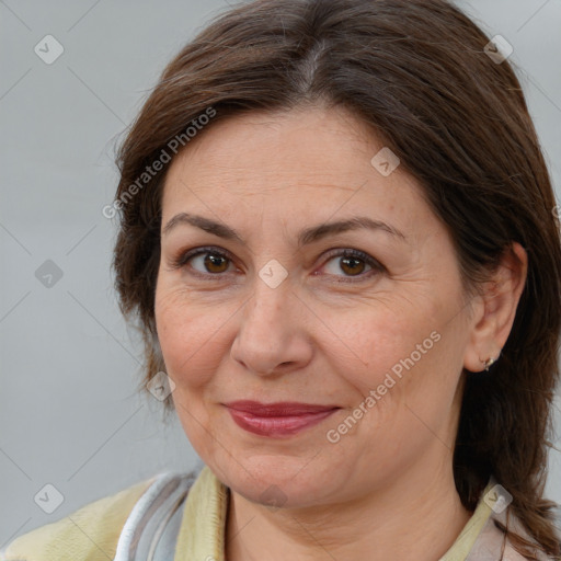 Joyful white adult female with medium  brown hair and brown eyes