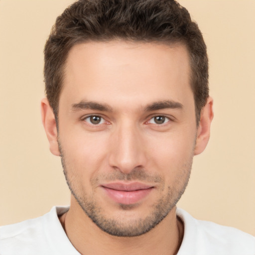 Joyful white young-adult male with short  brown hair and brown eyes