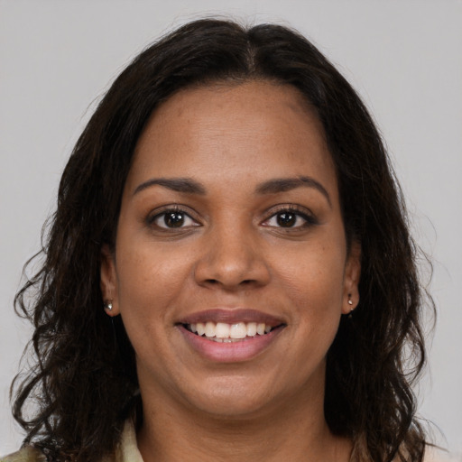Joyful latino young-adult female with long  brown hair and brown eyes