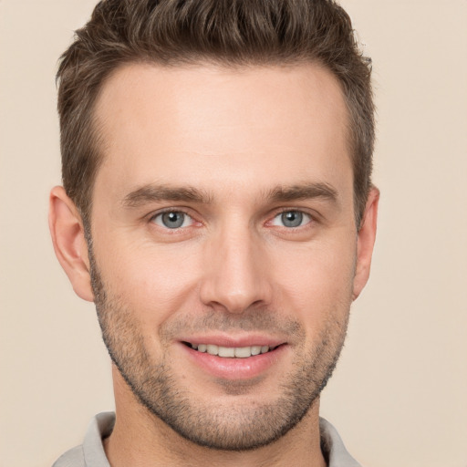 Joyful white young-adult male with short  brown hair and brown eyes