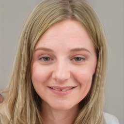 Joyful white young-adult female with long  brown hair and blue eyes