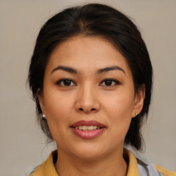 Joyful latino young-adult female with medium  brown hair and brown eyes