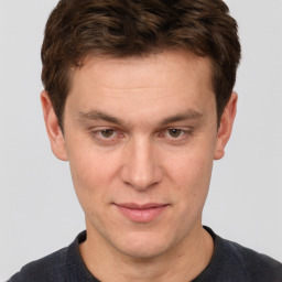 Joyful white adult male with short  brown hair and brown eyes