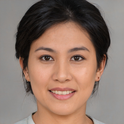 Joyful asian young-adult female with medium  brown hair and brown eyes