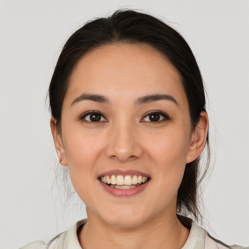 Joyful white young-adult female with medium  brown hair and brown eyes