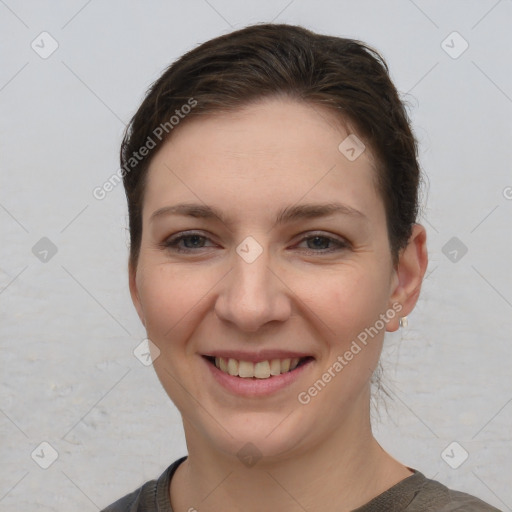 Joyful white young-adult female with short  brown hair and grey eyes