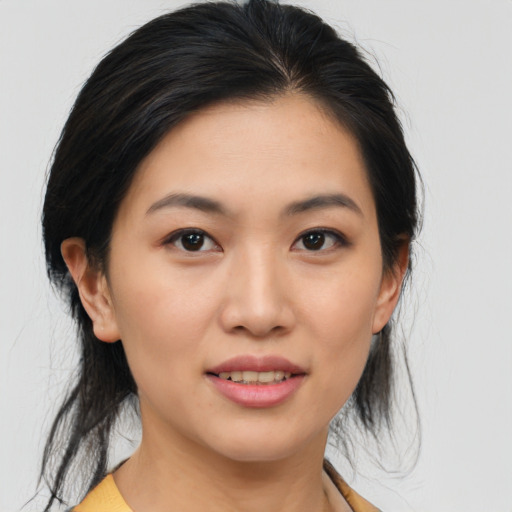 Joyful asian young-adult female with medium  brown hair and brown eyes