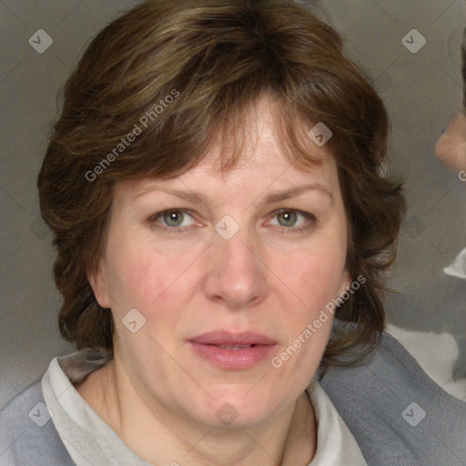 Joyful white adult female with medium  brown hair and blue eyes