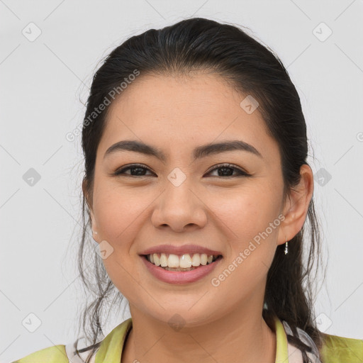 Joyful asian young-adult female with long  brown hair and brown eyes