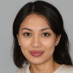 Joyful latino young-adult female with medium  brown hair and brown eyes