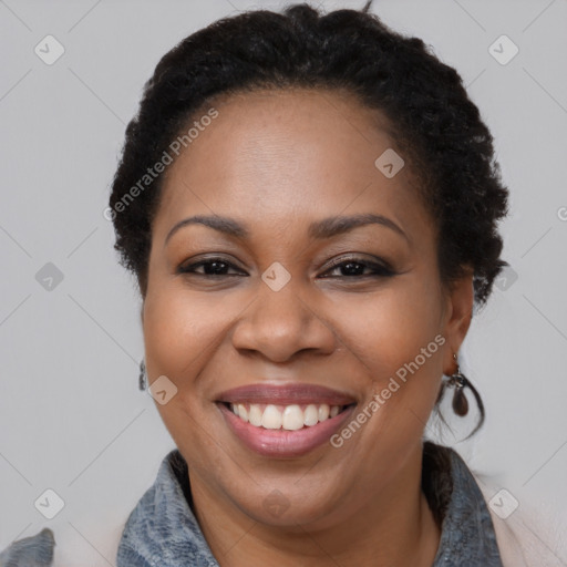 Joyful black adult female with short  brown hair and brown eyes