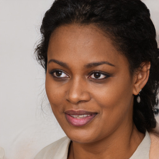 Joyful black young-adult female with medium  brown hair and brown eyes