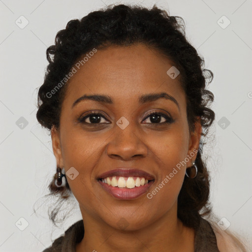 Joyful black young-adult female with long  brown hair and brown eyes