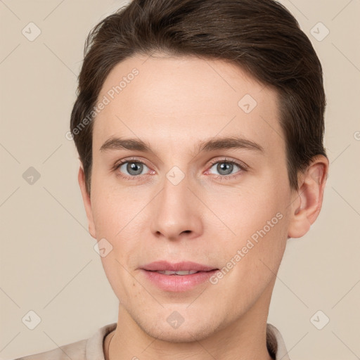 Joyful white young-adult male with short  brown hair and grey eyes