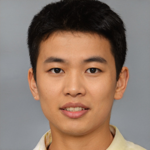 Joyful asian young-adult male with short  black hair and brown eyes