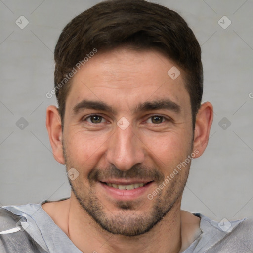 Joyful white adult male with short  brown hair and brown eyes