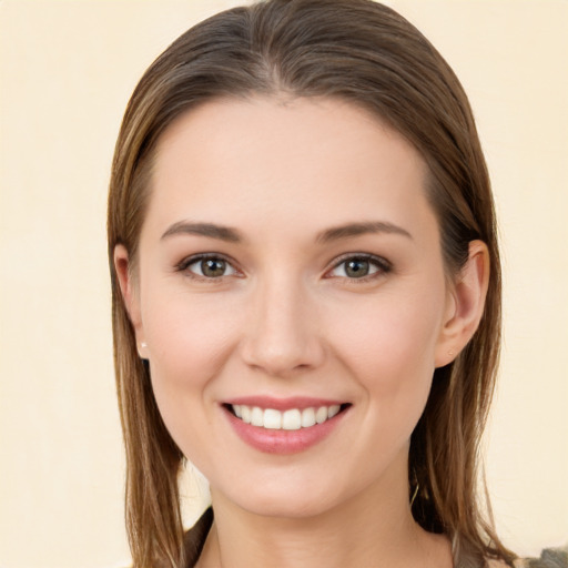 Joyful white young-adult female with long  brown hair and brown eyes