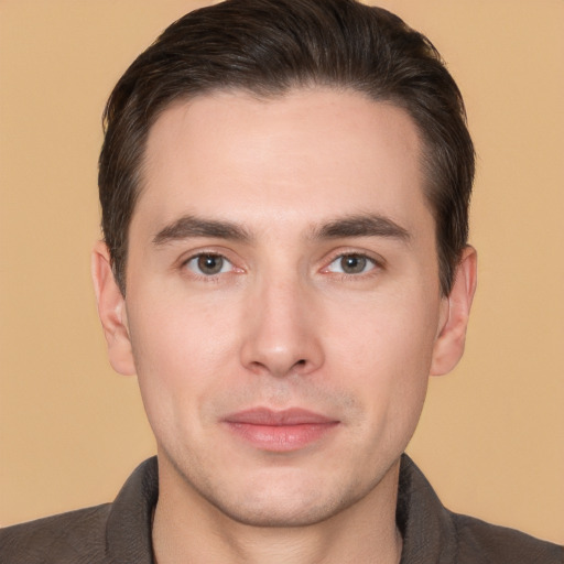 Joyful white young-adult male with short  brown hair and brown eyes