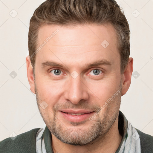 Joyful white adult male with short  brown hair and grey eyes