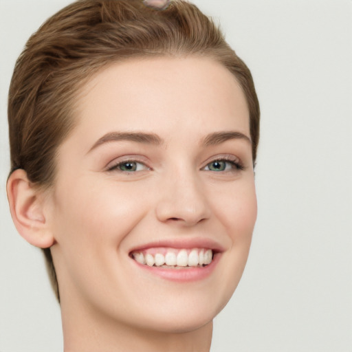 Joyful white young-adult female with short  brown hair and grey eyes