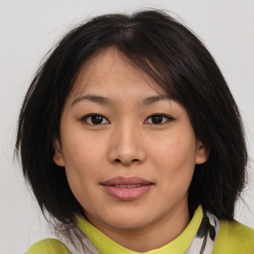 Joyful asian young-adult female with medium  brown hair and brown eyes