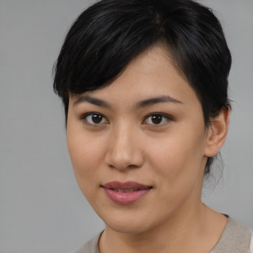Joyful asian young-adult female with medium  brown hair and brown eyes