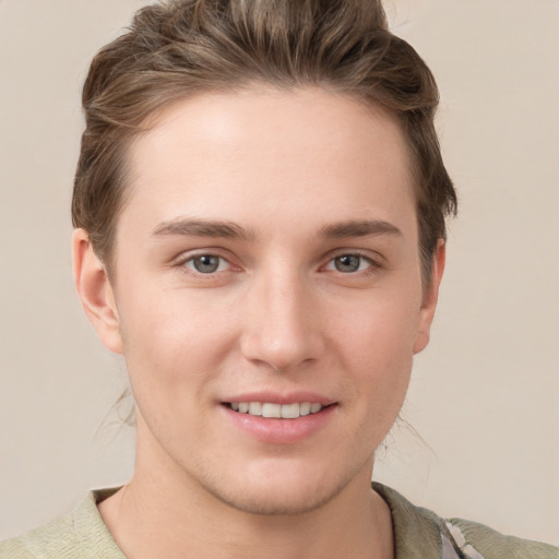 Joyful white young-adult female with short  brown hair and grey eyes