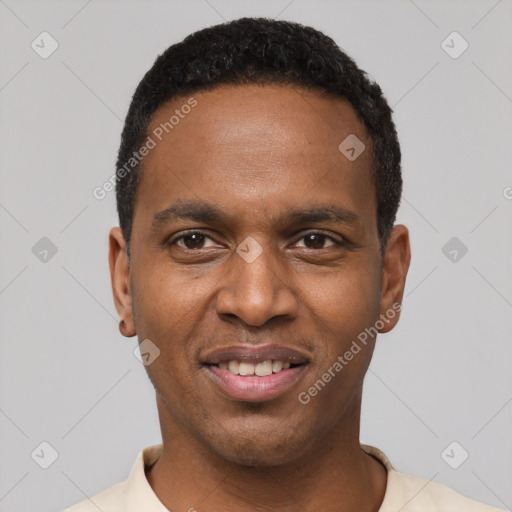 Joyful black young-adult male with short  black hair and brown eyes