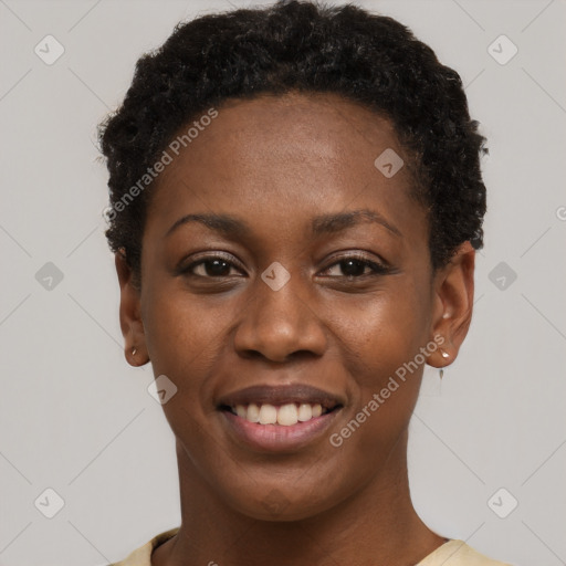 Joyful black young-adult female with short  black hair and brown eyes