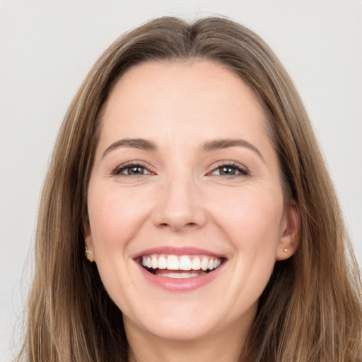 Joyful white young-adult female with long  brown hair and brown eyes