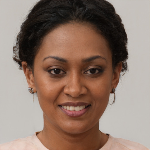 Joyful black young-adult female with short  brown hair and brown eyes