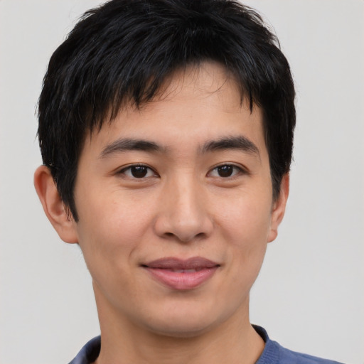 Joyful asian young-adult male with short  brown hair and brown eyes