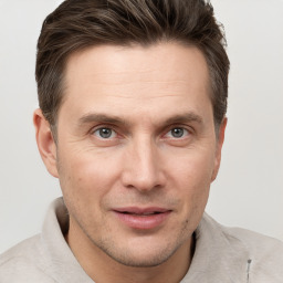 Joyful white adult male with short  brown hair and grey eyes