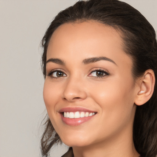 Joyful white young-adult female with long  brown hair and brown eyes