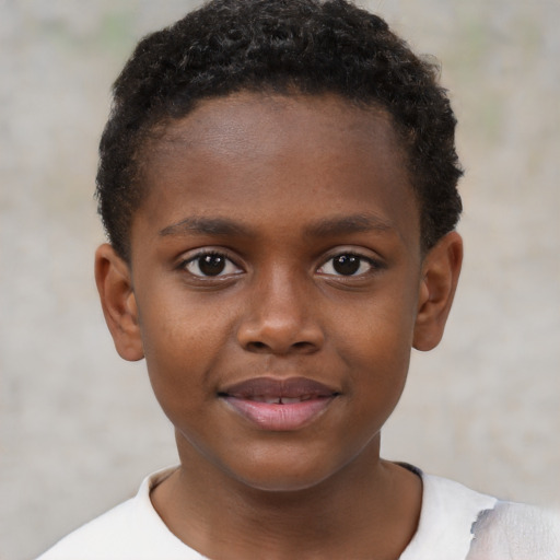 Joyful black child male with short  brown hair and brown eyes