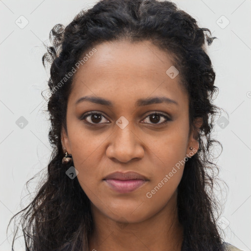 Joyful black young-adult female with long  black hair and brown eyes