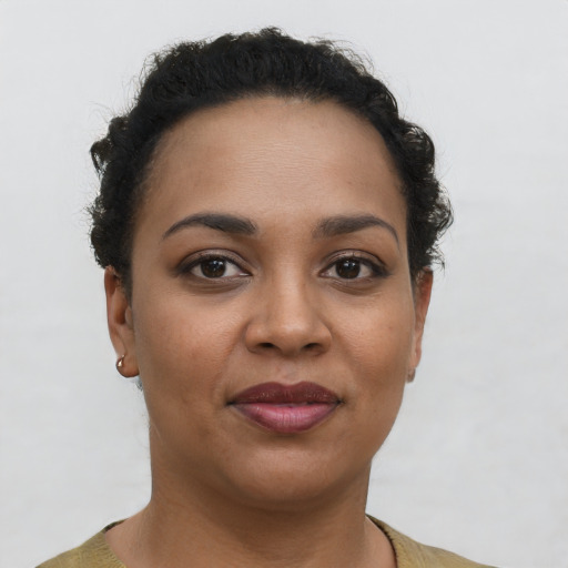 Joyful latino young-adult female with short  brown hair and brown eyes