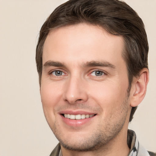 Joyful white young-adult male with short  brown hair and brown eyes