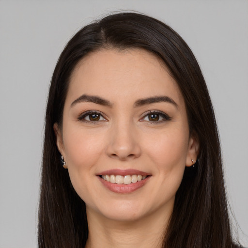 Joyful white young-adult female with long  brown hair and brown eyes